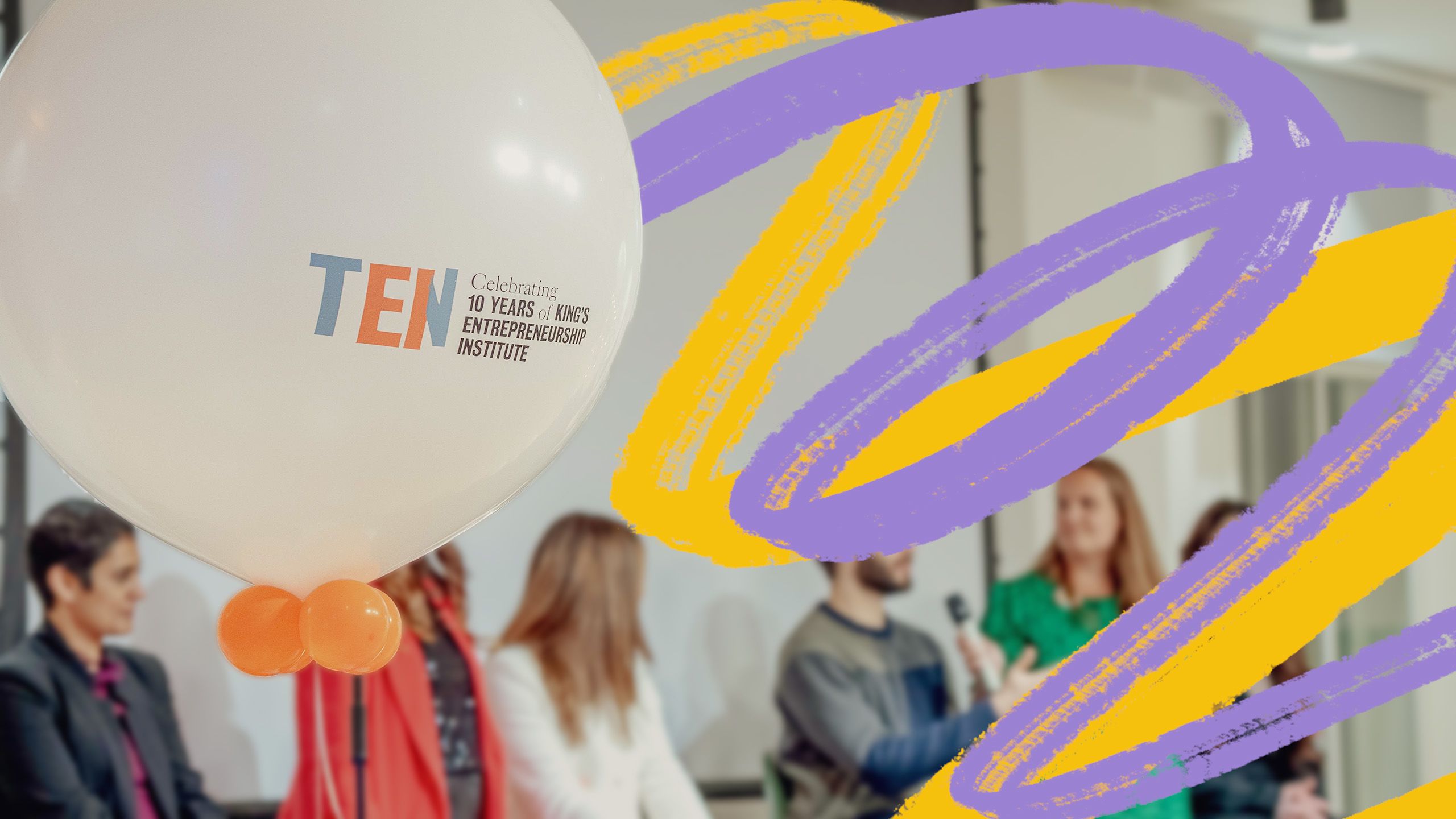A balloon that says 'celebrating ten years of King's entrepreneurship Institute'. Behind the balloon is a panel of speakers.