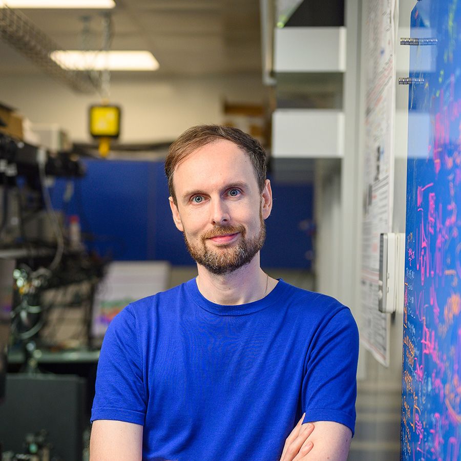 Dr James Millen standing in a laboratory setting