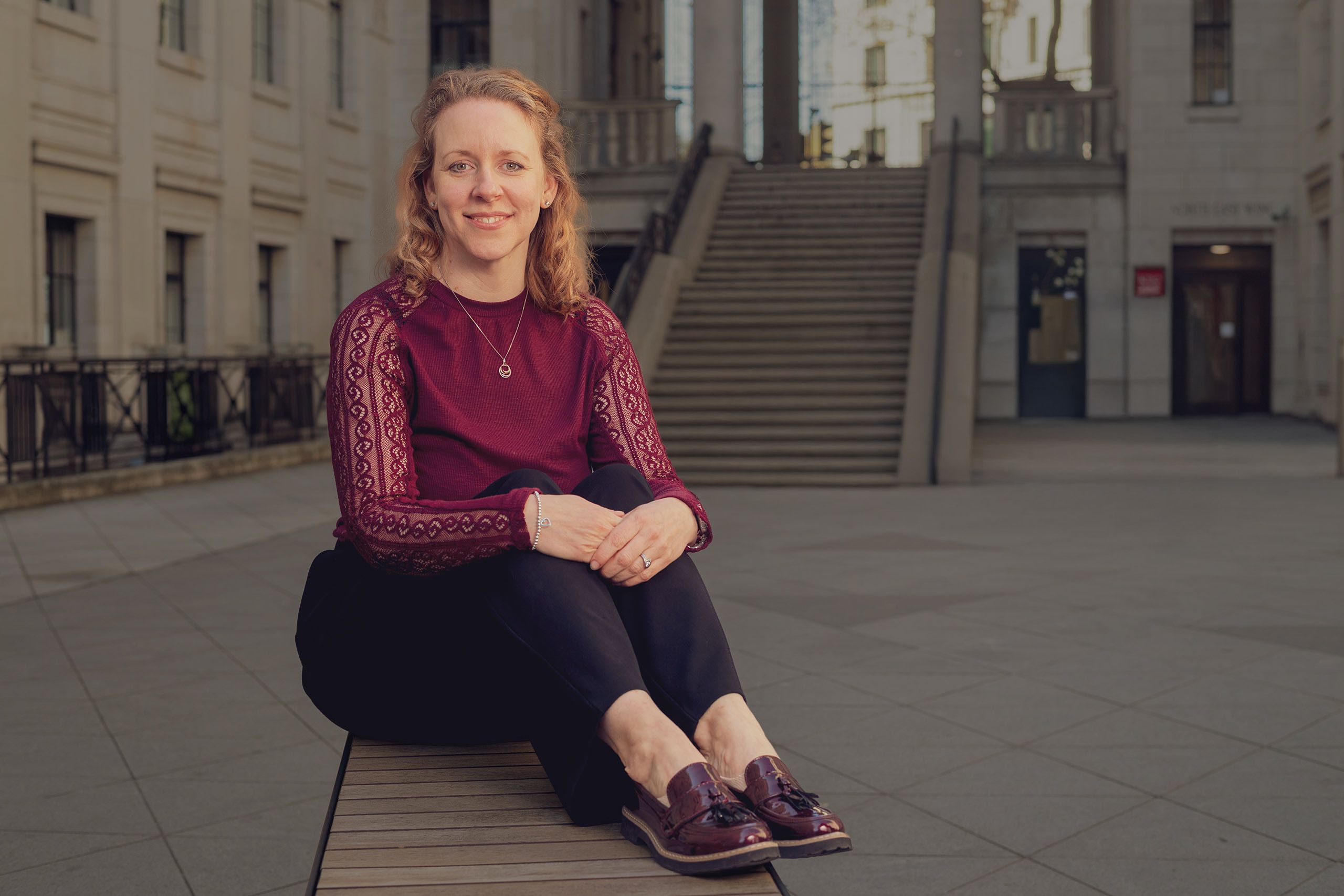 Emma Keith is pictured smiling whilst sat in the Bush House Quad.