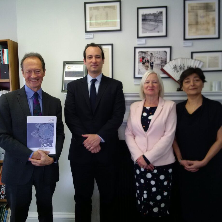 Left to right: Professor David Mosey holding a copy of the FAC-1 contract, alongside Eric Franco, Professor Gillian Douglas, and Darya Bahram