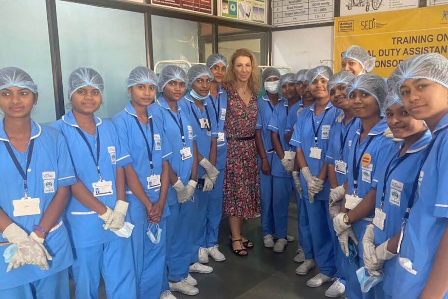 A group of young female nurses in India, wearing blue nurse uniforms